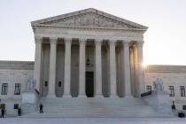 The sun rises behind the U.S. Supreme Court, Tuesday, Oct. 11, 2022, in Washington. The Biden a ...