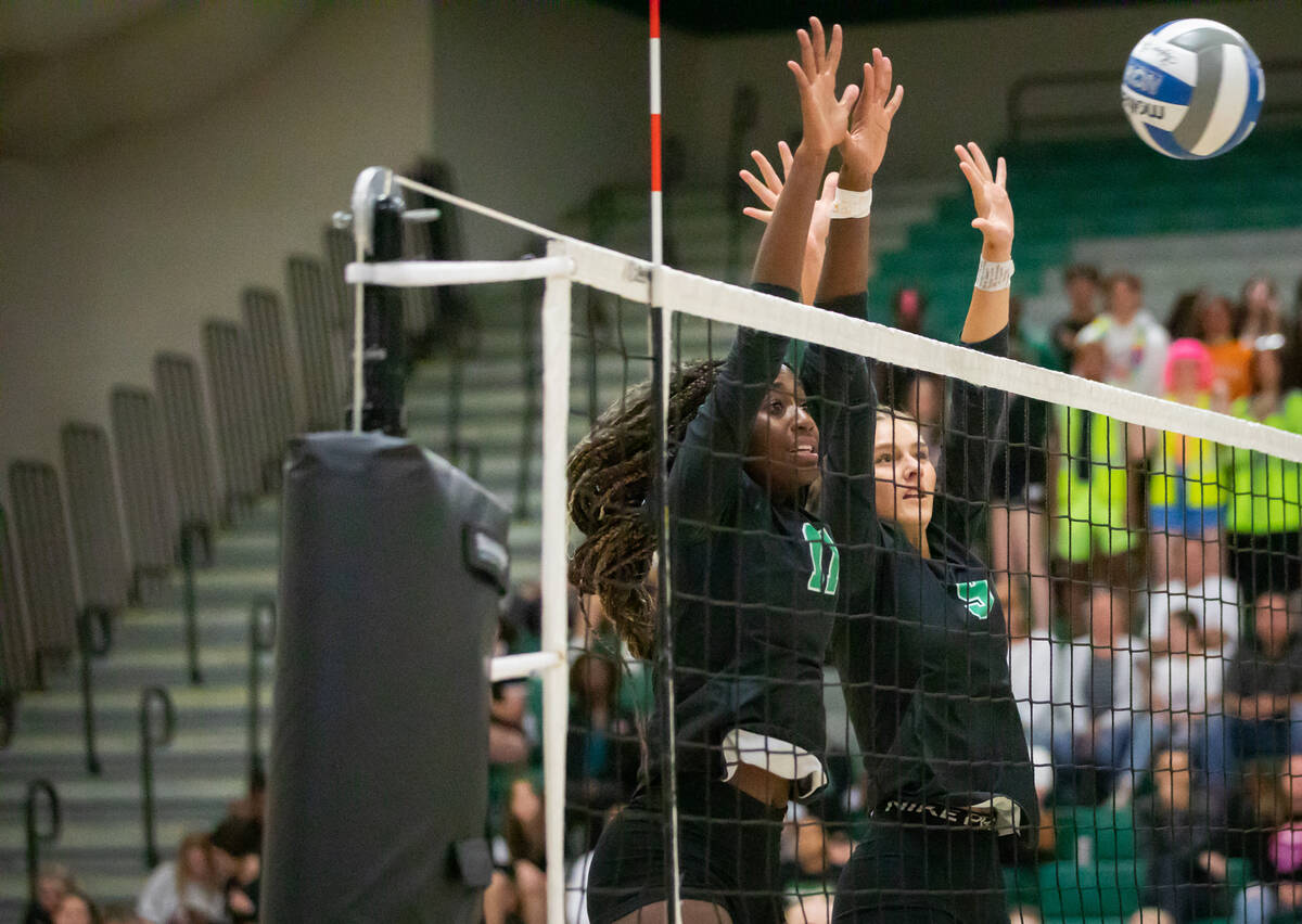 Palo Verde’s Deloris Nangah (11) and Lincoln Common (9) block the ball during a volleyba ...