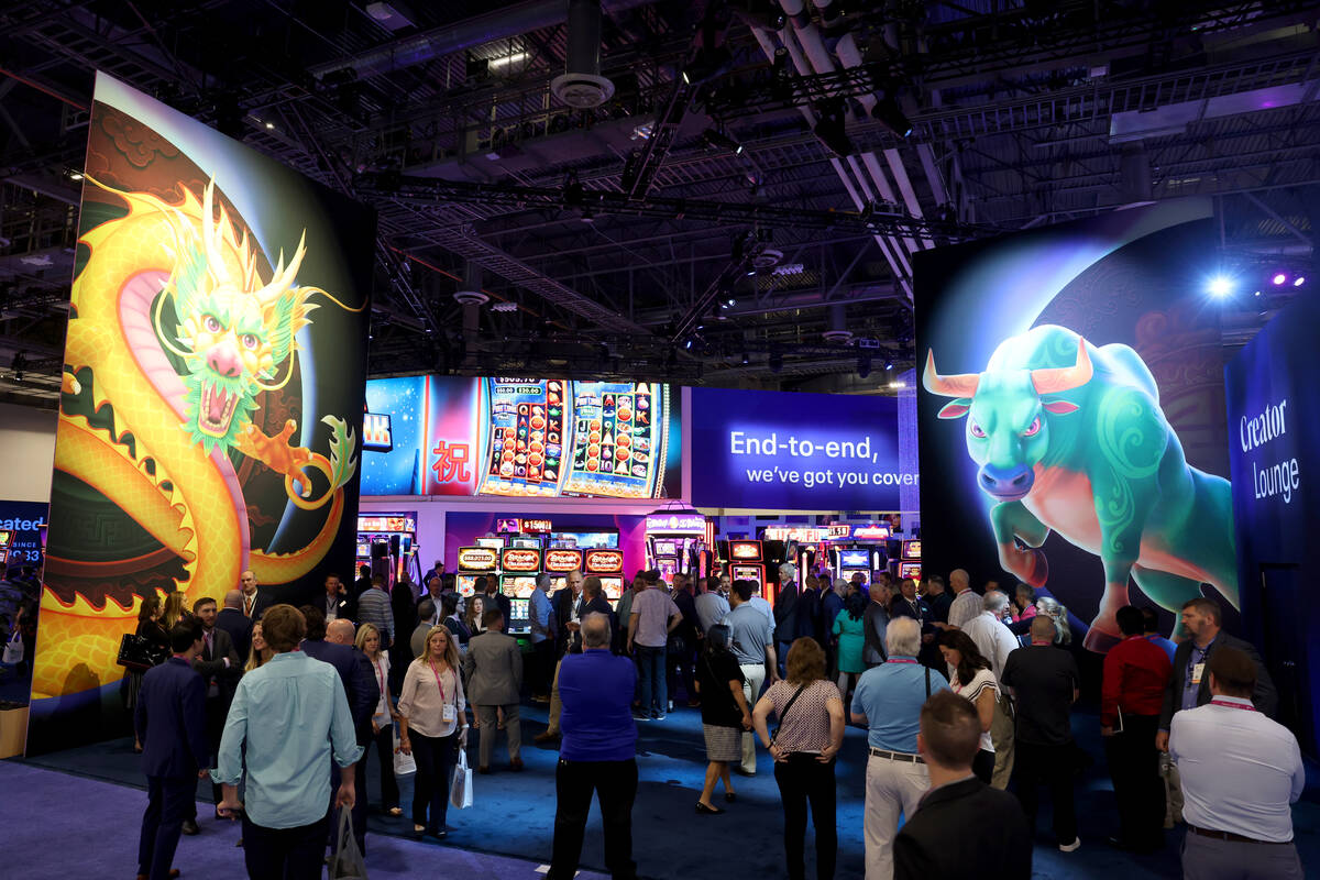 Conventioneers check out the Light & Wonder booth on the show floor at the Global Gaming Ex ...