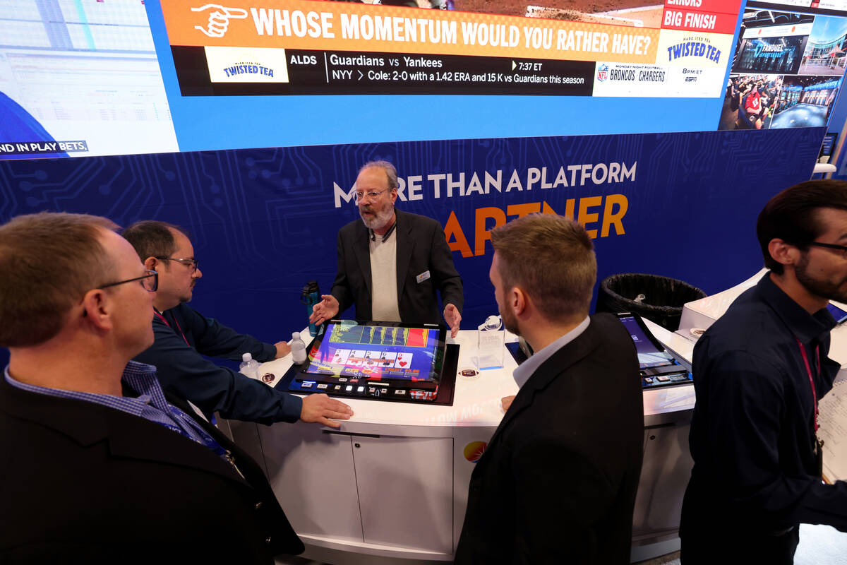 International Game Technology Senior Product Manager Poker Products Sid Lazarus shows a bar top ...