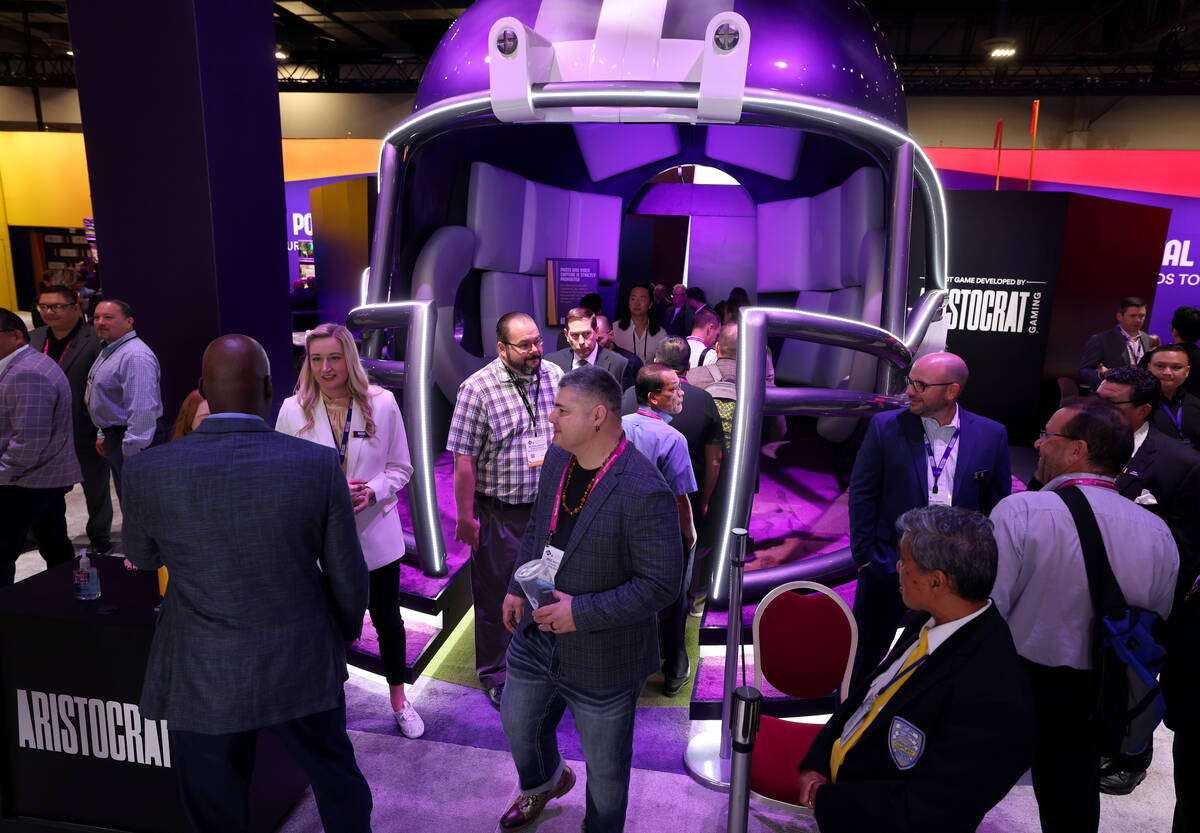 Customers walk through a giant football helmet to get a sneak peak at NFL-branded slot machines ...