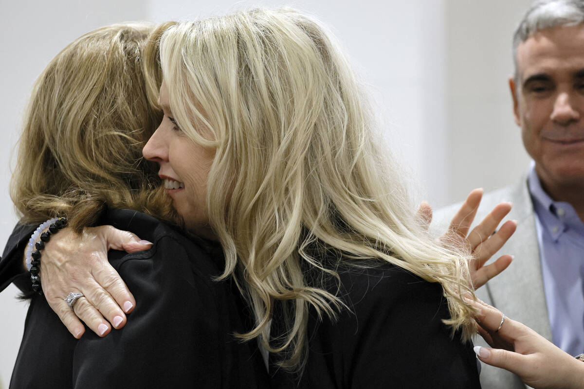 Gena Hoyer hugs Assistant State Attorney Carolyn McCann in court as they await the jury decisio ...