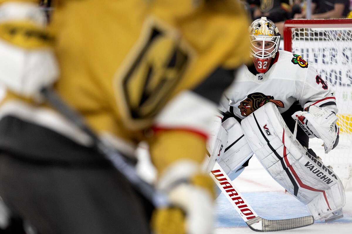 Blackhawks goaltender Alex Stalock (32) anticipates the puck while the Golden Knights prepare t ...