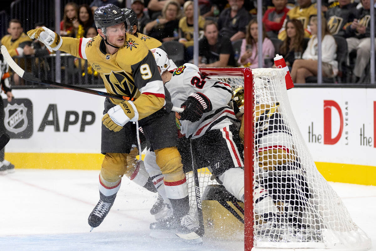 Blackhawks center Sam Lafferty (24) skates into Golden Knights goaltender Logan Thompson (36) i ...