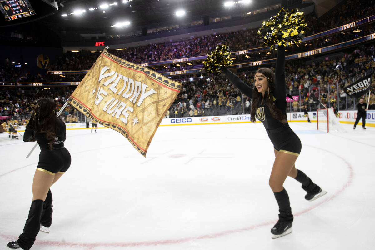 The Knight Guard celebrate with fans after the Golden Knights won their first regular season ho ...