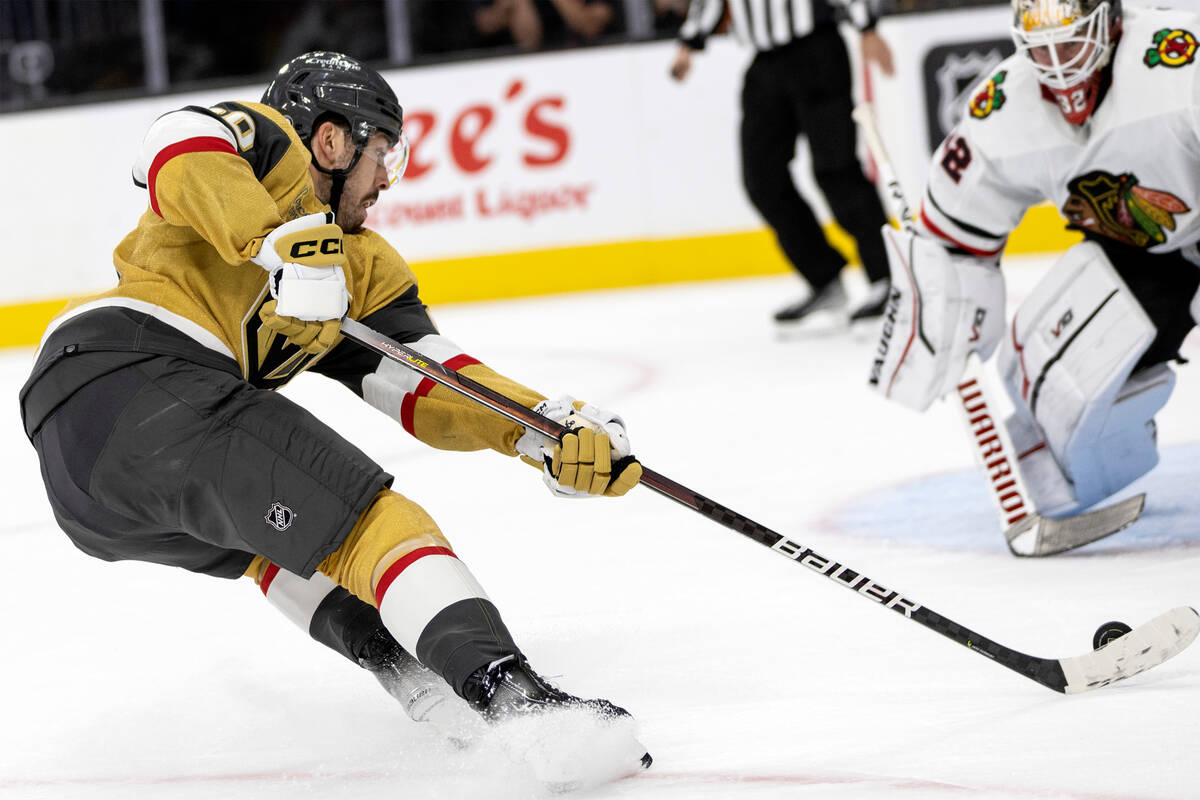 Golden Knights center Chandler Stephenson (20) attempts to score on Blackhawks goaltender Alex ...