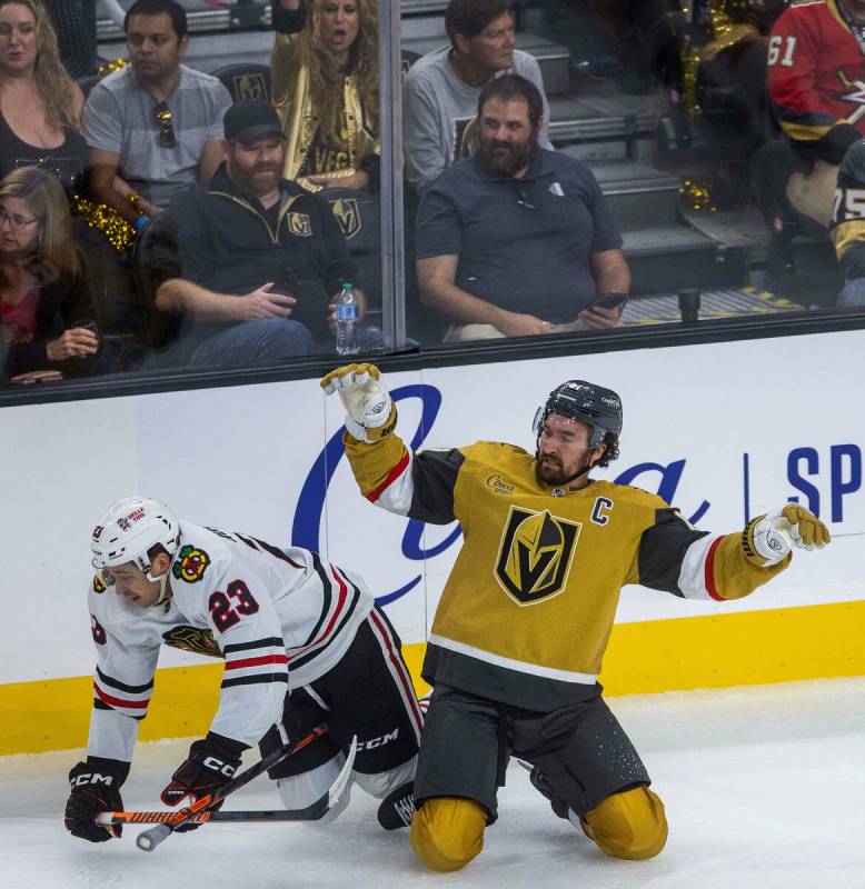 Chicago Blackhawks center Philipp Kurashev (23) is tripped up boy Golden Knights right wing Mar ...