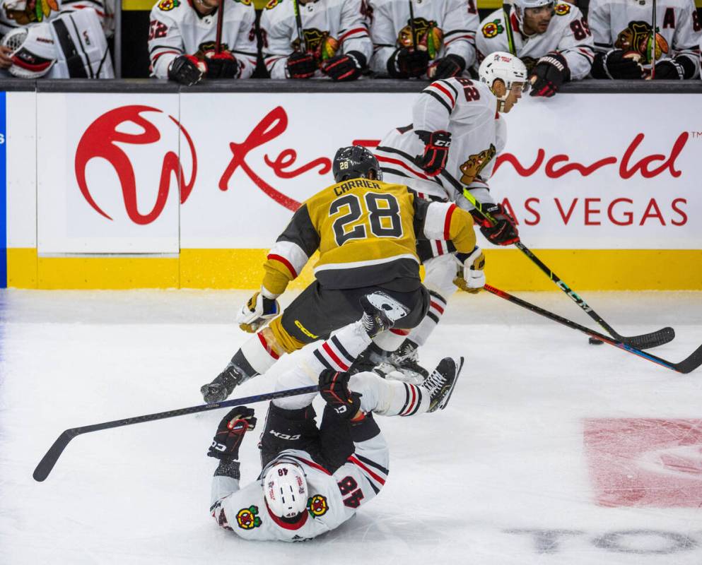 Chicago Blackhawks defenseman Caleb Jones (82) takes control of the puck versus Golden Knights ...