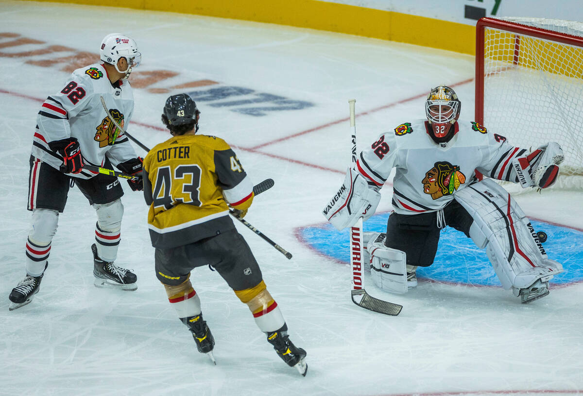 Golden Knights center Paul Cotter (43) gets a score past Chicago Blackhawks goaltender Alex Sta ...