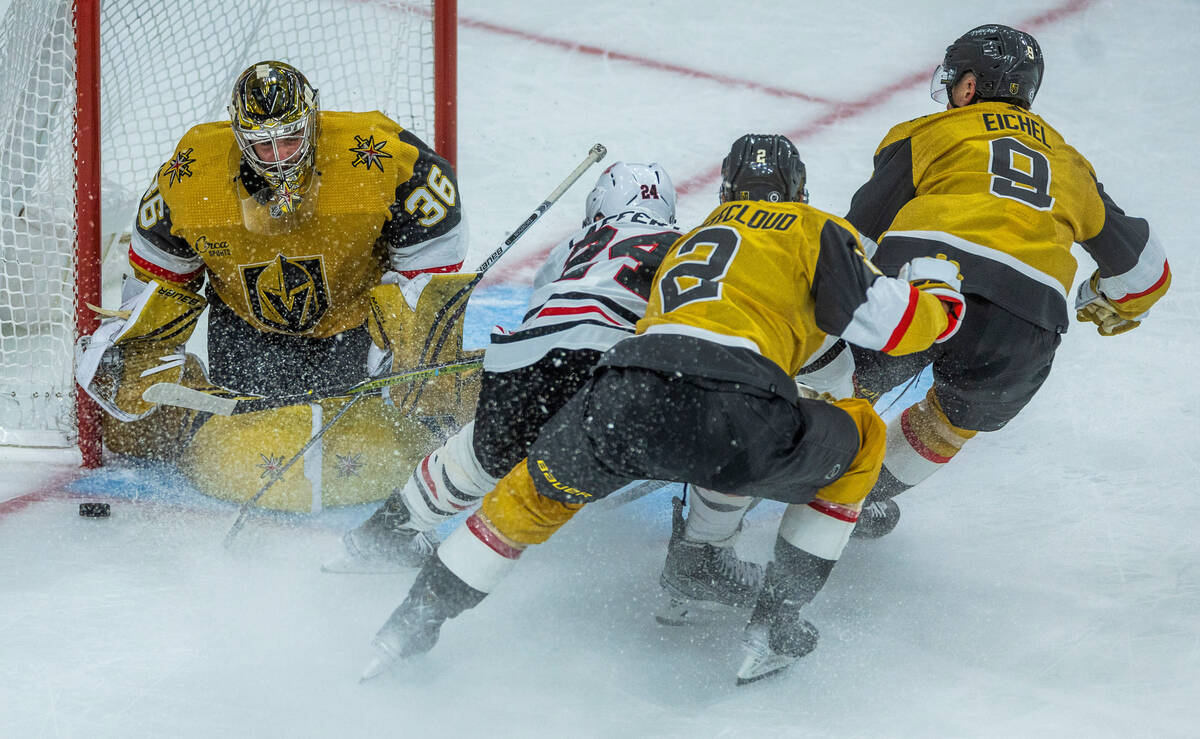 Golden Knights goaltender Logan Thompson (36) readies to be crashed into by Chicago Blackhawks ...