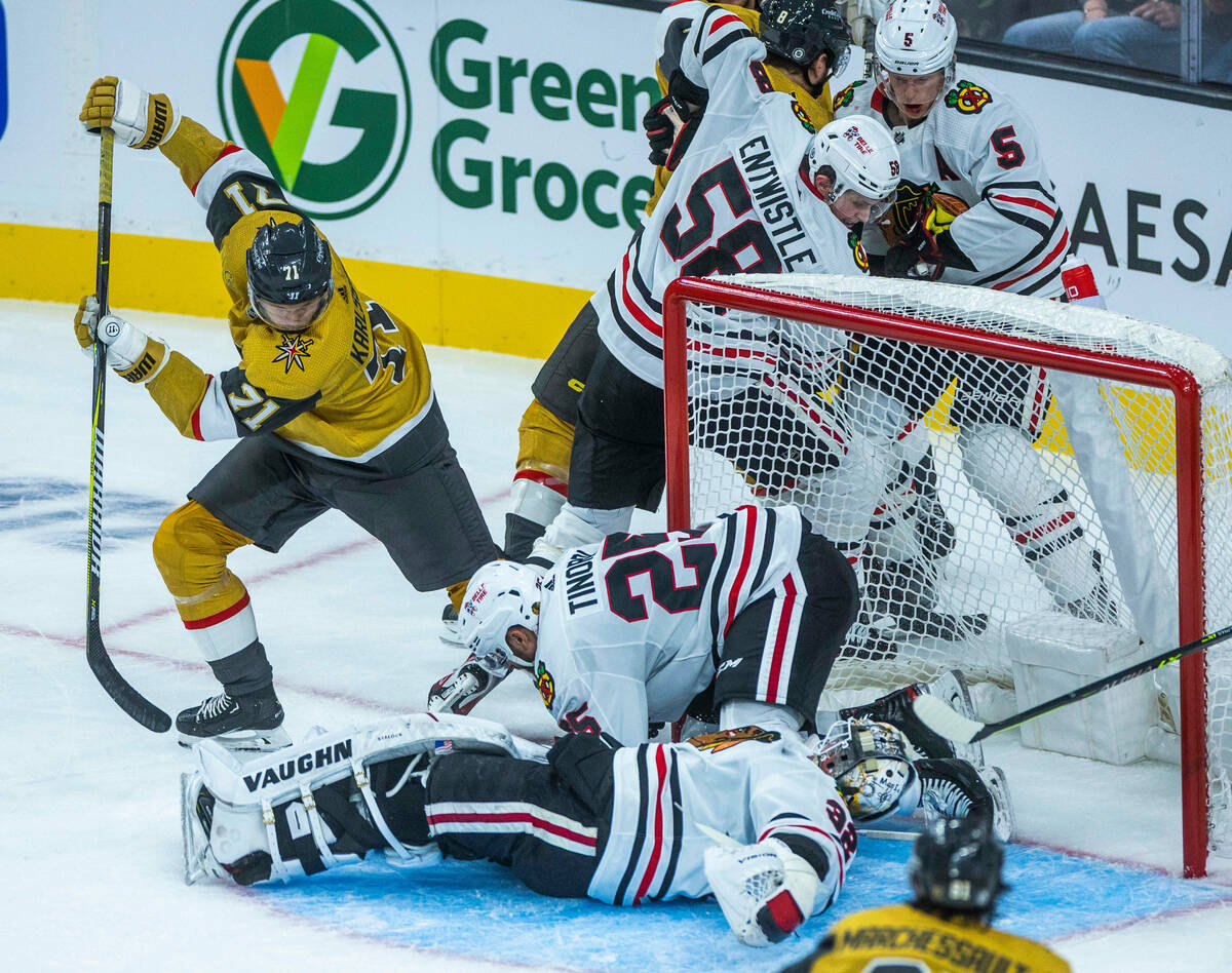 Golden Knights center William Karlsson (71) shorts the puck being stopped by Chicago Blackhawks ...