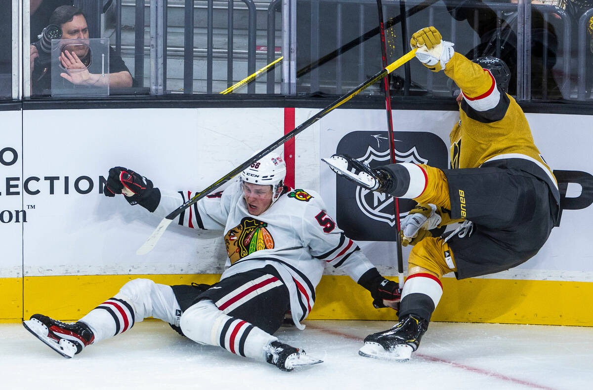 Chicago Blackhawks defenseman Connor Murphy (58) collides with Golden Knights center Jack Eiche ...