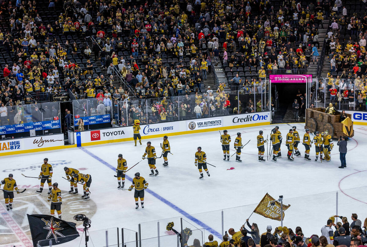 Golden Knights players celebrate their win over the Chicago Blackhawks 1-0 with the fans follow ...