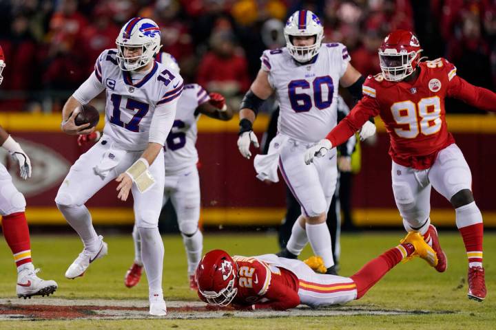 Buffalo Bills quarterback Josh Allen (17) runs from Kansas City Chiefs safety Juan Thornhill (2 ...