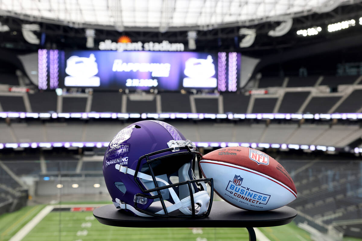 A football and helmet at Allegiant Stadium in Las Vegas promoting Super Bowl LVIII before a new ...
