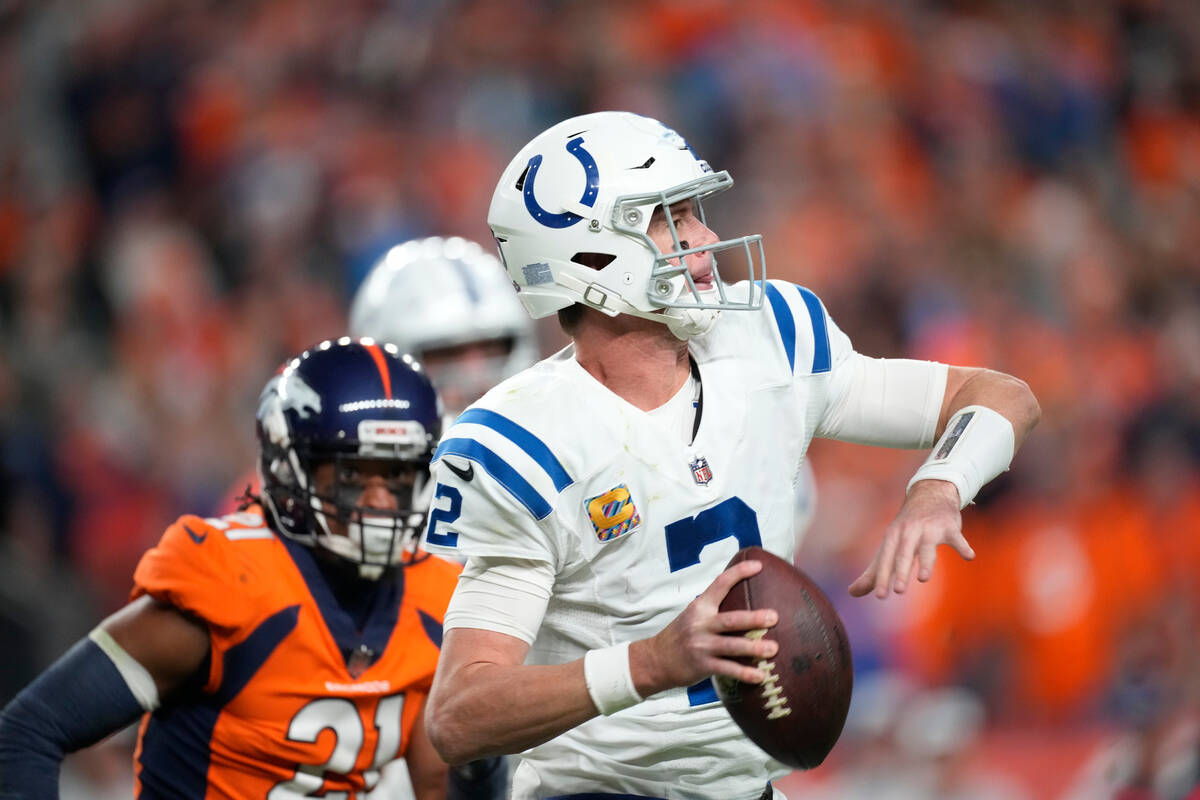 Indianapolis Colts quarterback Matt Ryan (2) is pursued by Denver Broncos cornerback K'Waun Wil ...