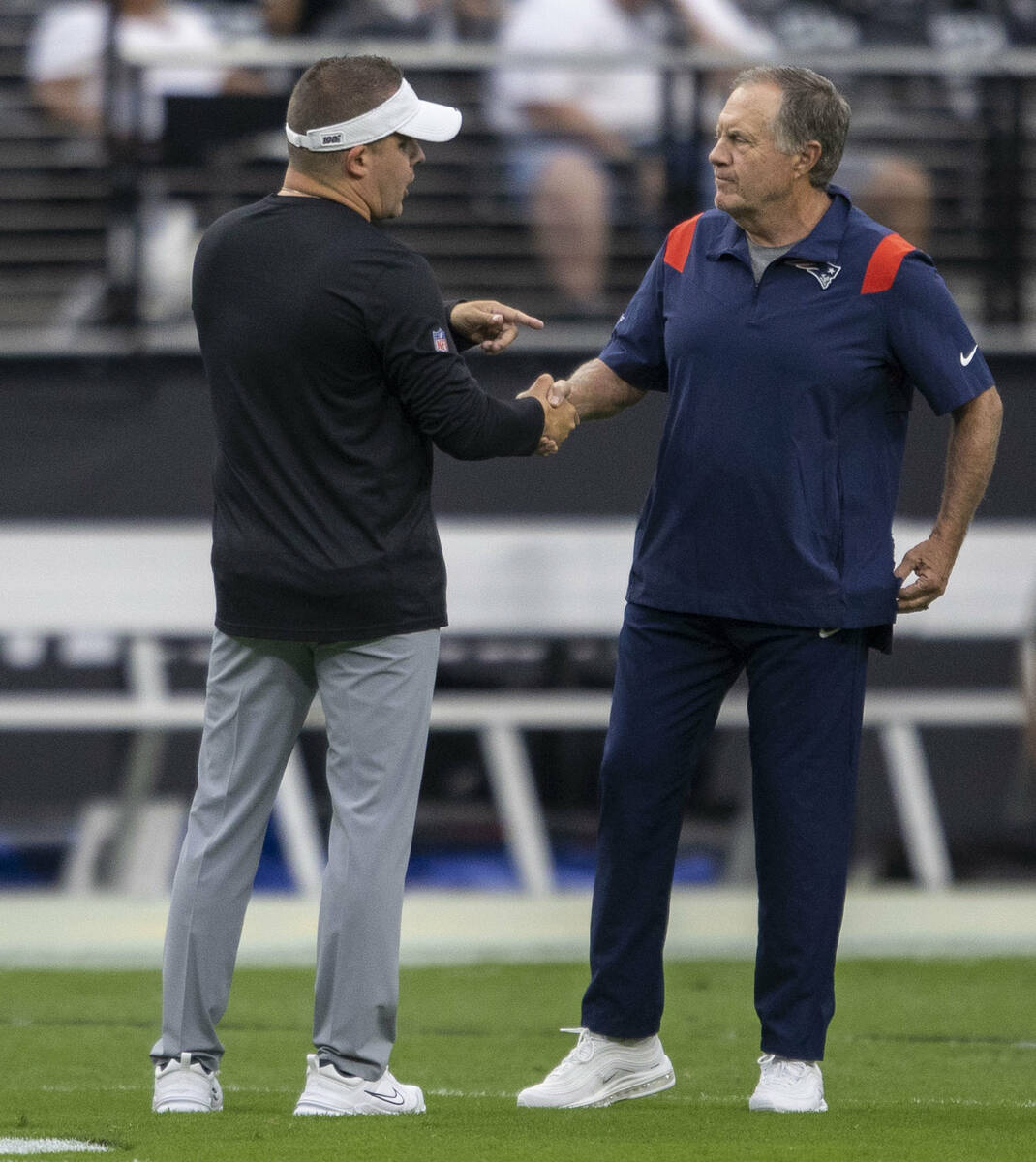 Raiders head coach Josh McDaniels and New England Patriots head coach Bill Belichick shake hand ...