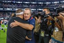 New England Patriots Head Coach Bill Belichick hugs Raiders Head Coach Josh McDaniels on the fi ...