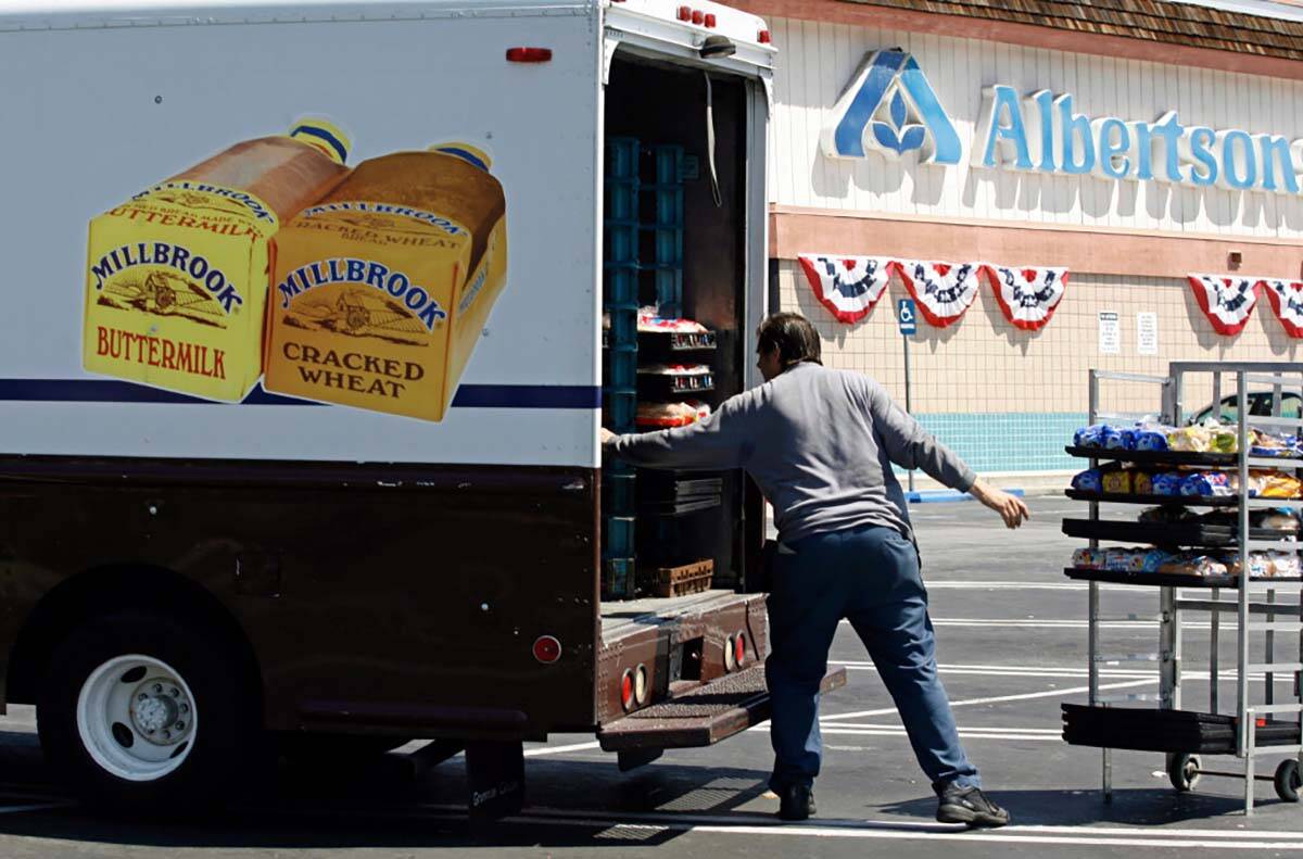 FILE - Mitch Maddox, a bread route salesman, loads bread Tuesday, May 30, 2006, outside the Eag ...