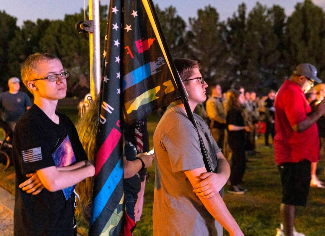 Kenneth Condon, left, and his brother Conner gathered during a candlelight vigil for fallen Las ...