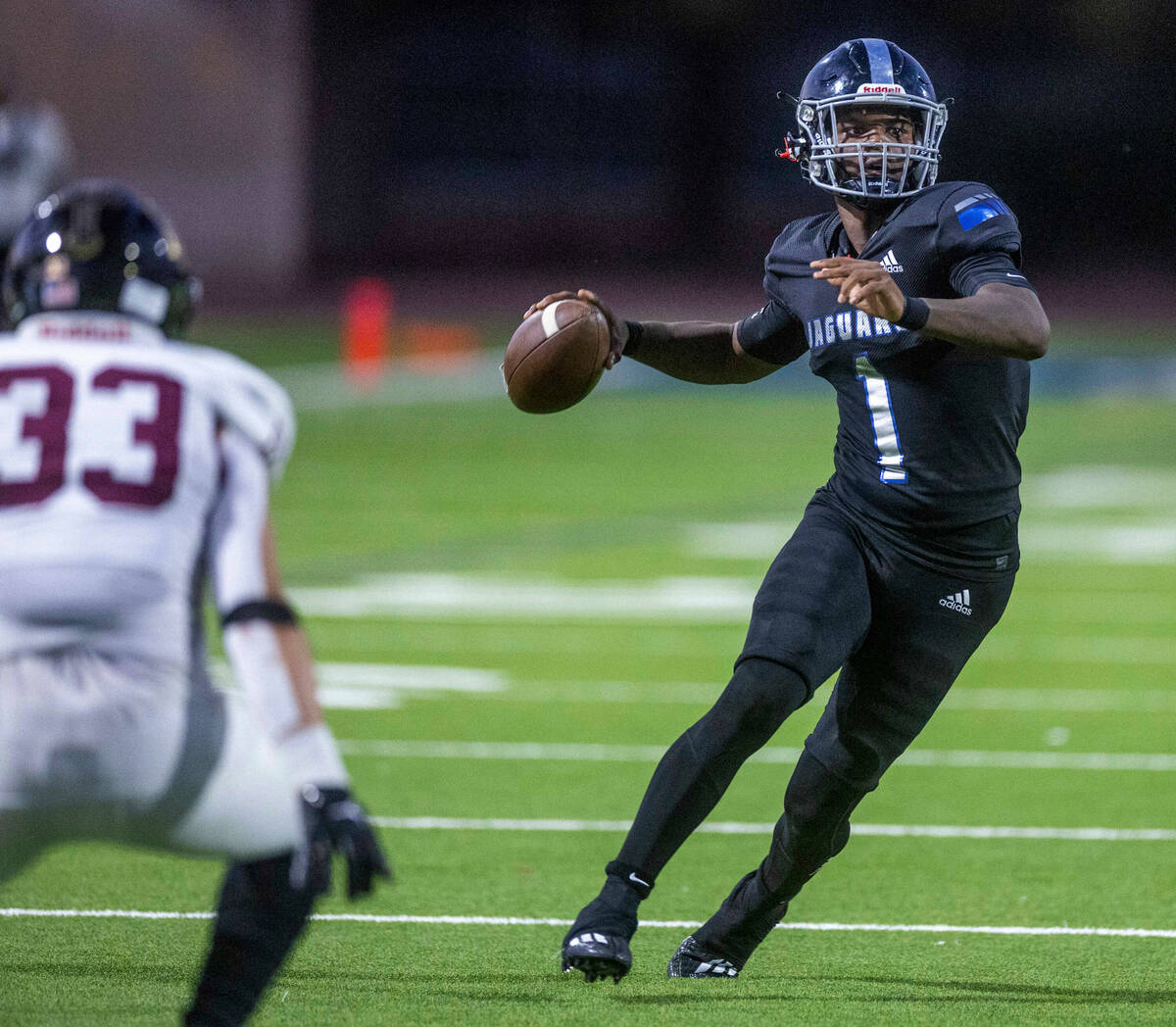 Desert Pines QB Marquis Roby (1) looks to pass versus Faith Lutheran's defense during the first ...