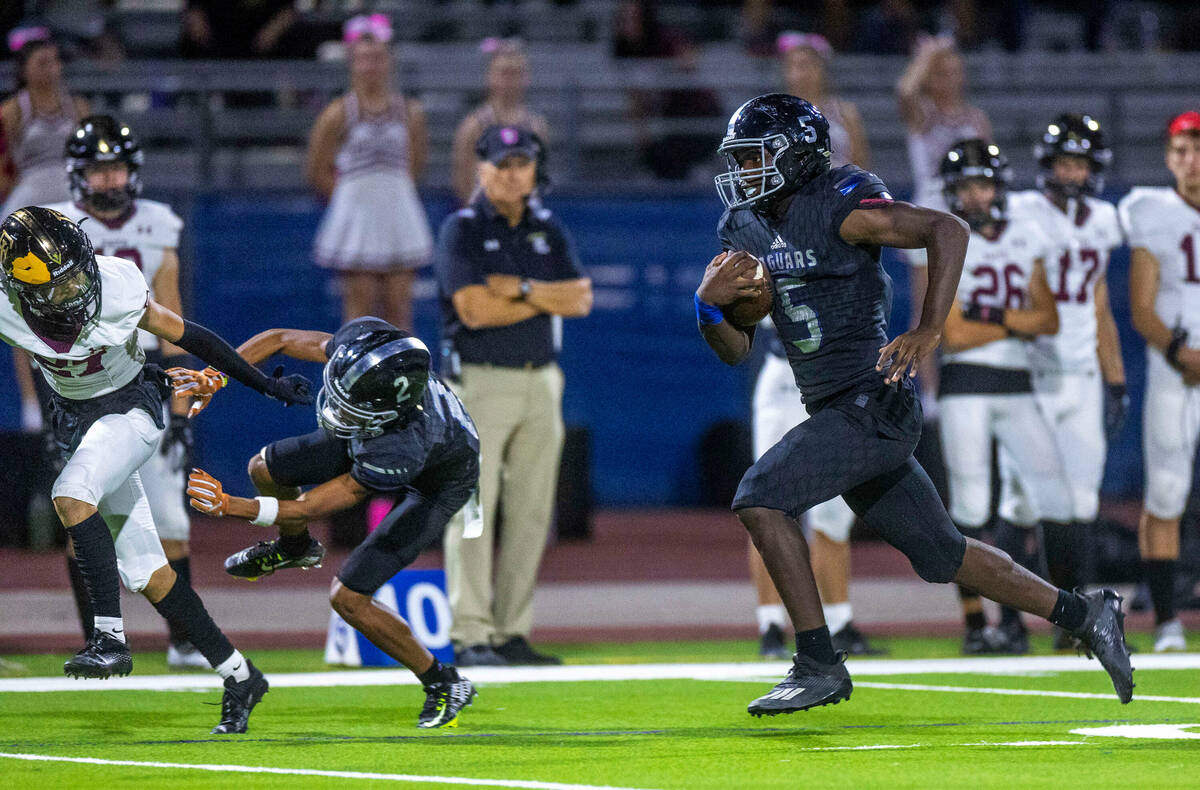 Desert Pines RB Greg Burrell (5) looks to the end zone again over Faith Lutheran during the sec ...
