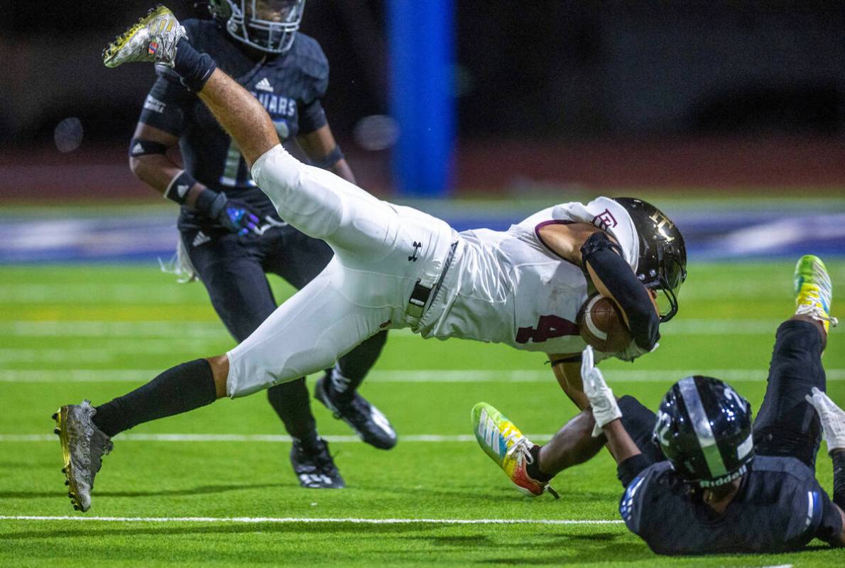 Faith Lutheran's WR Vicentico (Tico) Pringle (4) is stopped after a run by Desert Pines FS Trey ...