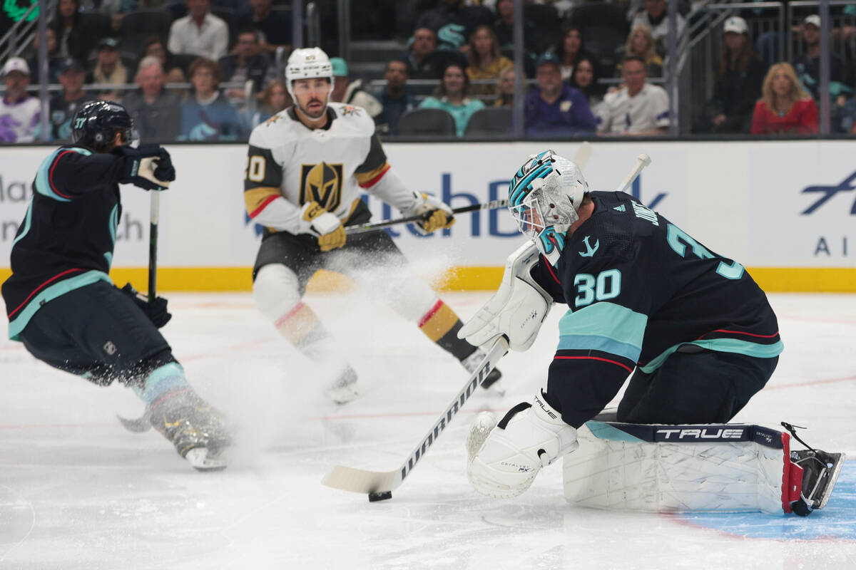 Seattle Kraken goaltender Martin Jones protects the puck as Vegas Golden Knights center Chandle ...