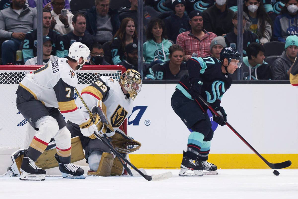 Seattle Kraken center Jaden Schwartz, right, gets the puck in front of Vegas Golden Knights goa ...