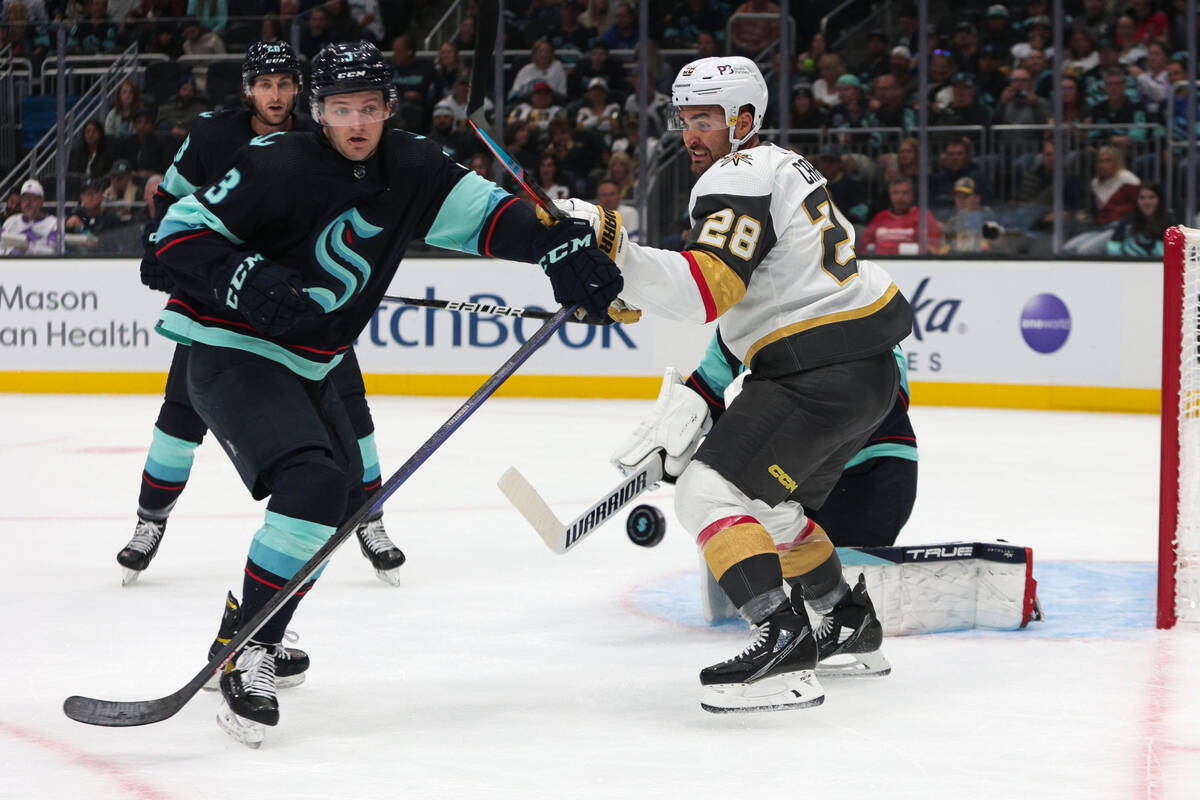 Vegas Golden Knights left wing William Carrier (28) and Seattle Kraken defenseman Will Borgen c ...