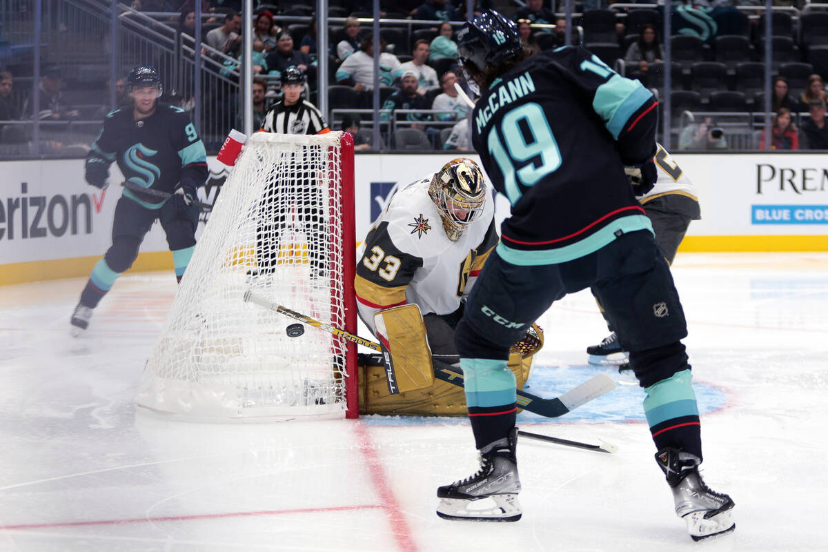 Vegas Golden Knights goaltender Adin Hill blocks a shot as Seattle Kraken left wing Jared McCan ...