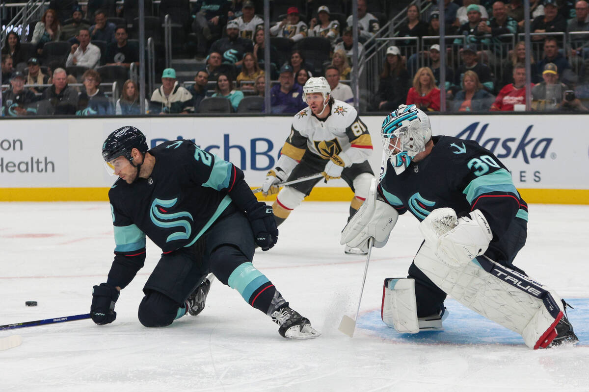 Seattle Kraken defenseman Vince Dunn, left, and goaltender Martin Jones defend as Vegas Golden ...