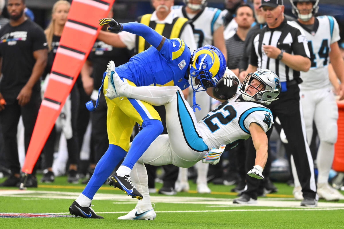 Los Angeles Rams cornerback Jalen Ramsey, top, tackles Carolina Panthers running back Christian ...