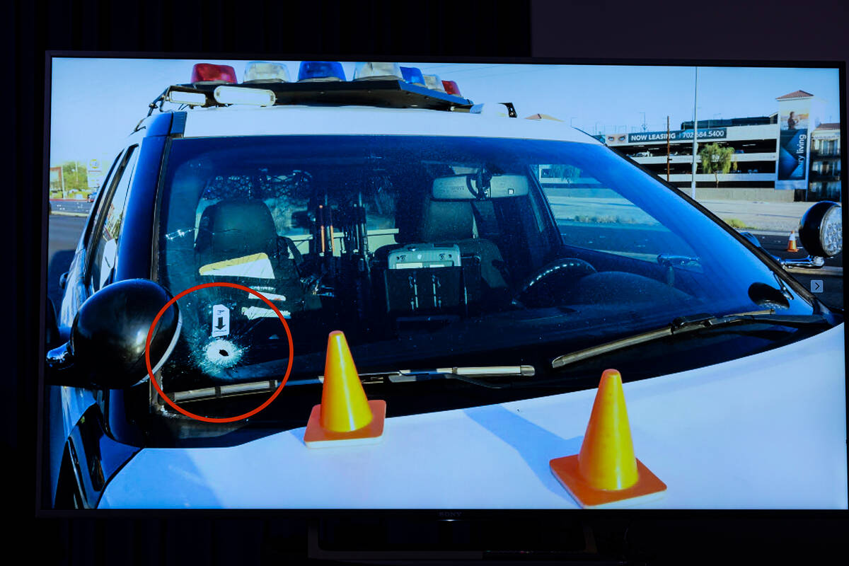 A bullet hole is seen in the window of a police vehicle following officer-involved shooting tha ...