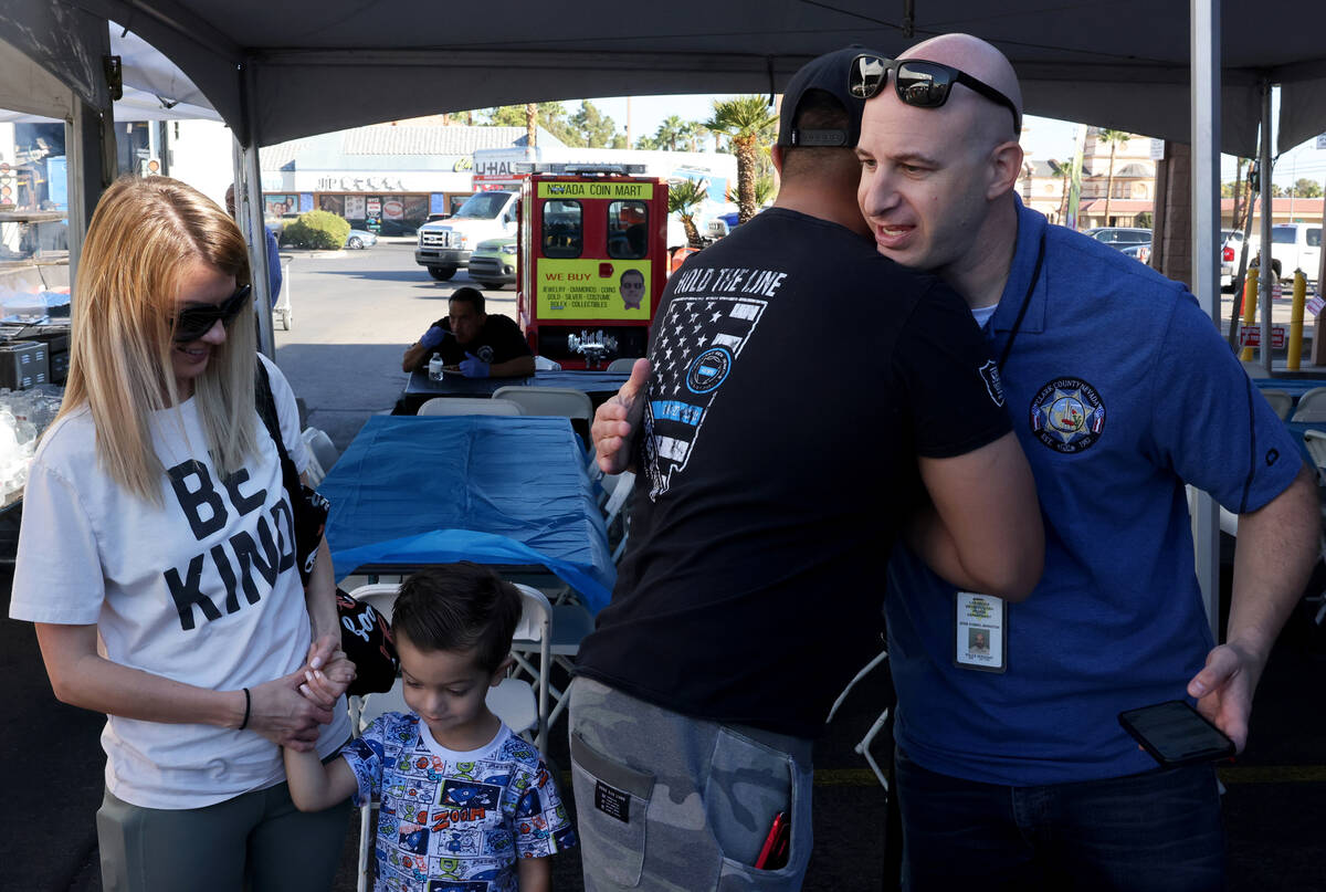 Injured Police Officers Fund Vice President Jesse Kommel-Bernstein, right, gets a hug from Lt. ...