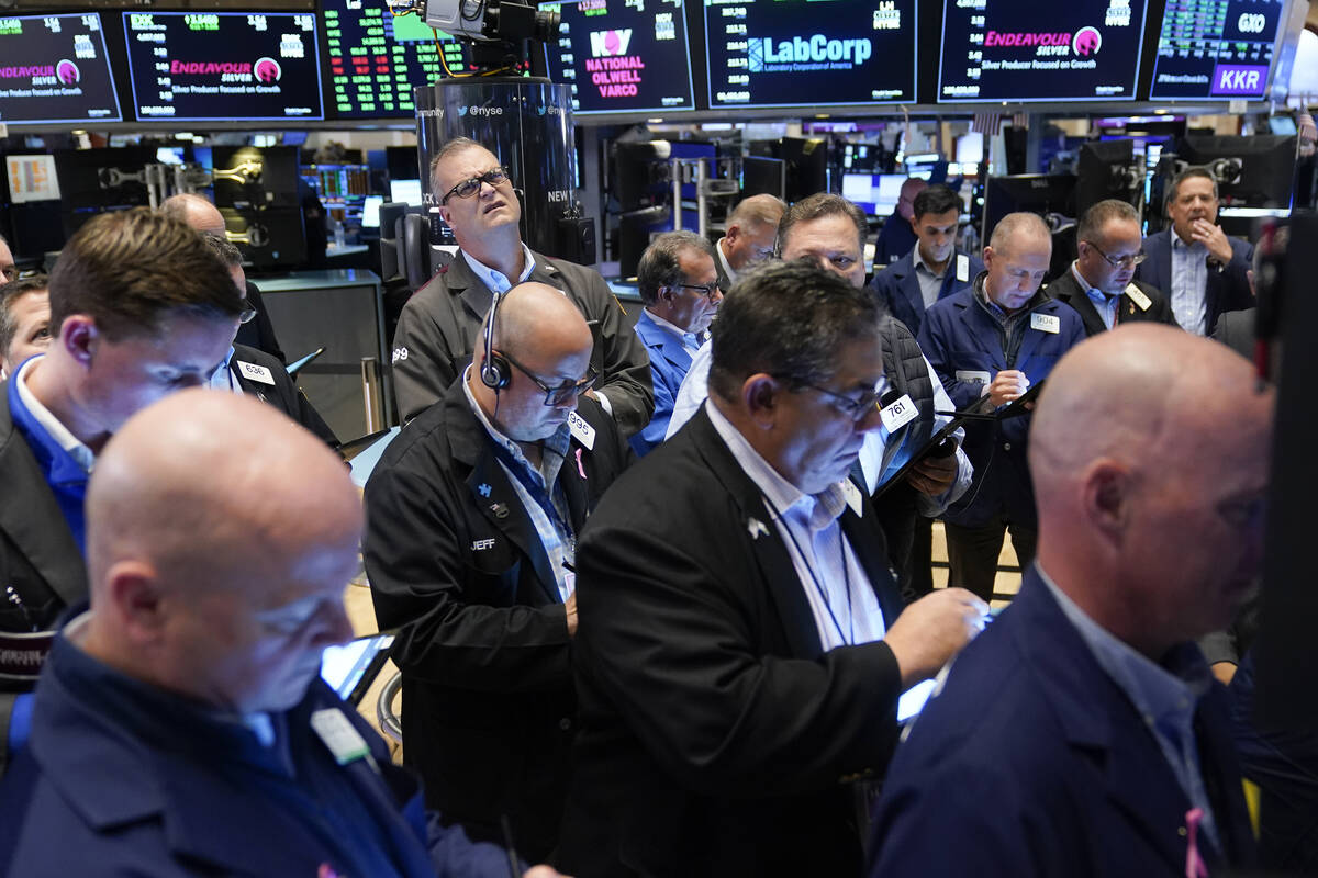 FILE--Traders gather around a post as Twitter shares resume trading on the floor at the New Yor ...
