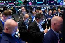 FILE--Traders gather around a post as Twitter shares resume trading on the floor at the New Yor ...
