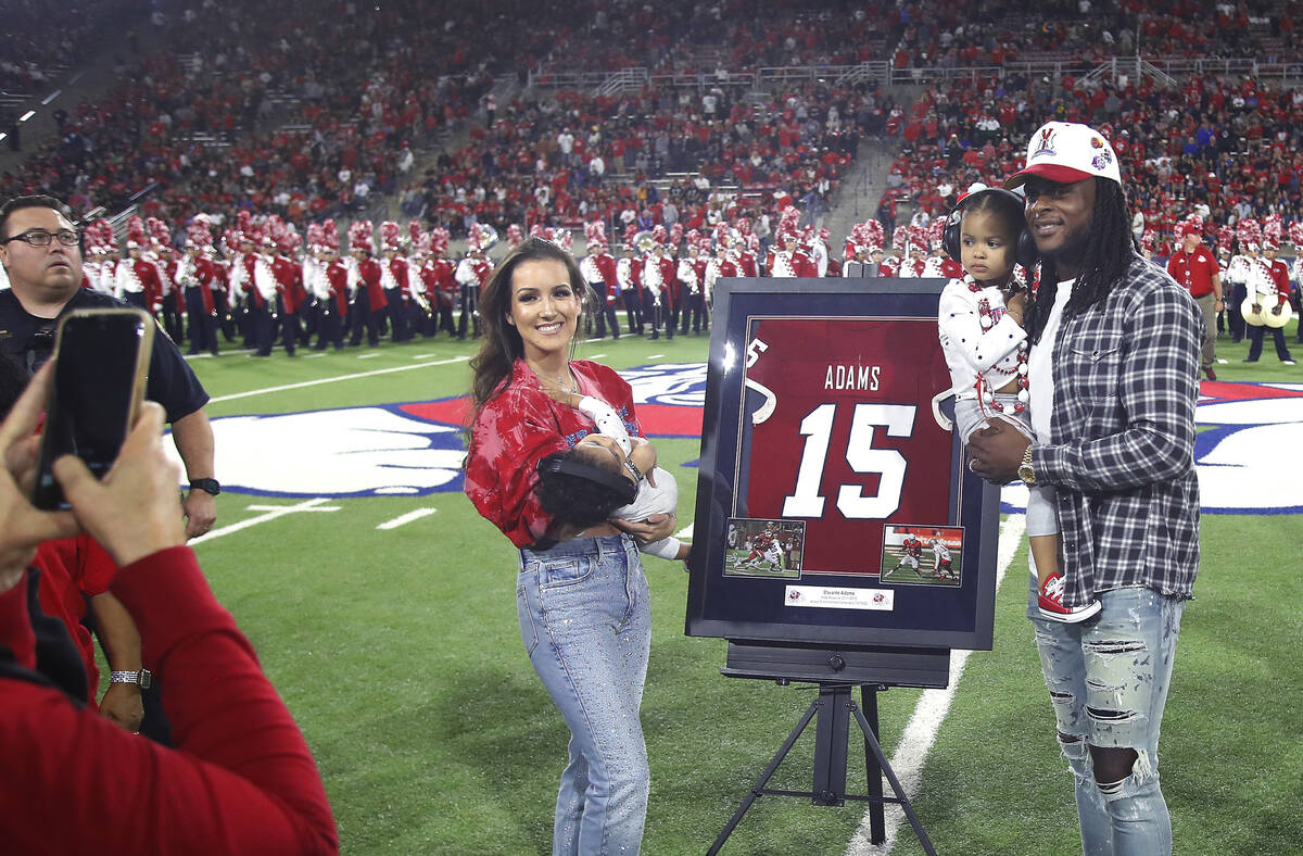 Las Vegas Raiders' Davante Adams, right, a former Fresno State player, has his jersey number re ...