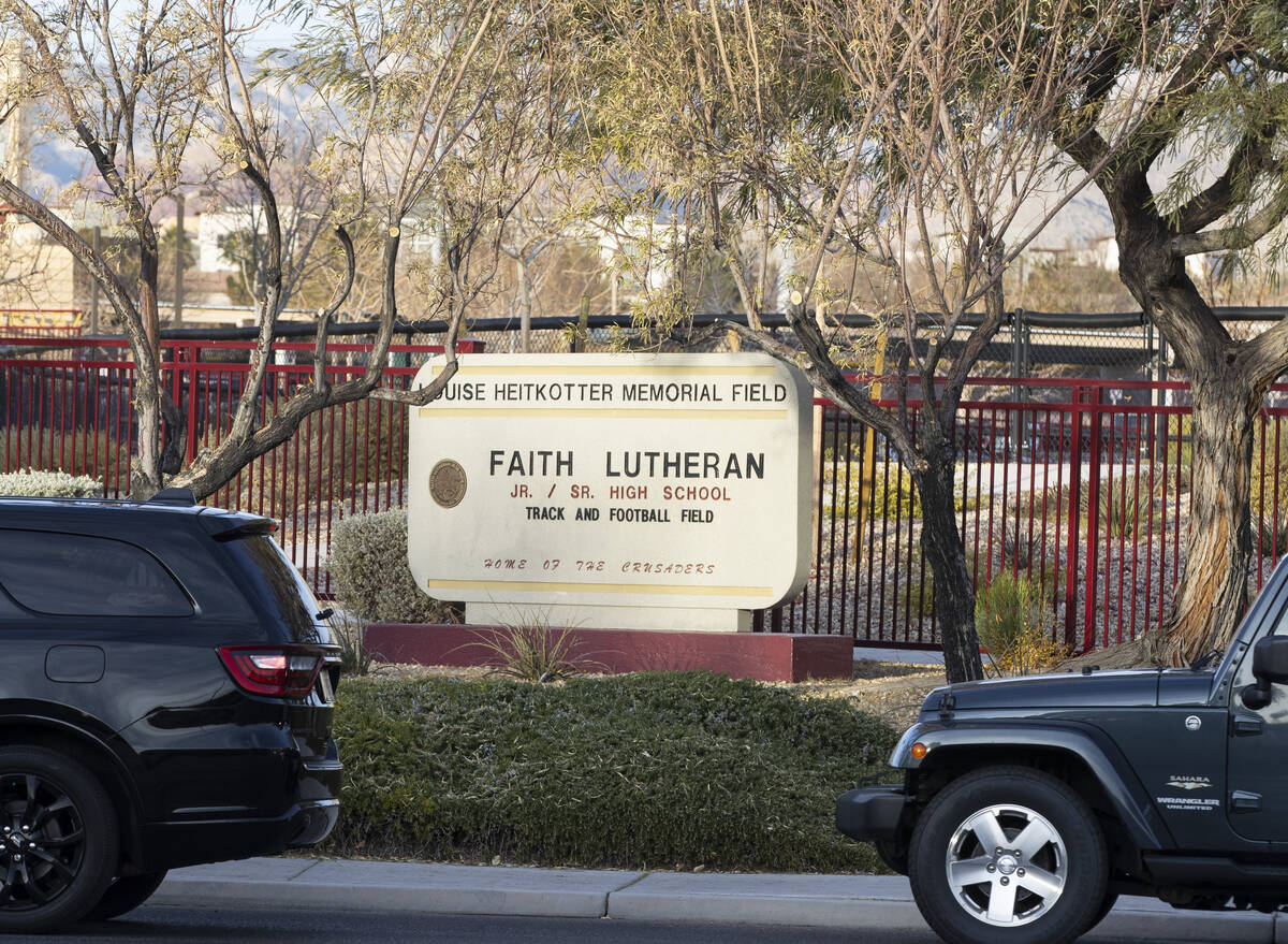 Parents in their cars lined up to enter Faith Lutheran Middle School and High School to drop of ...