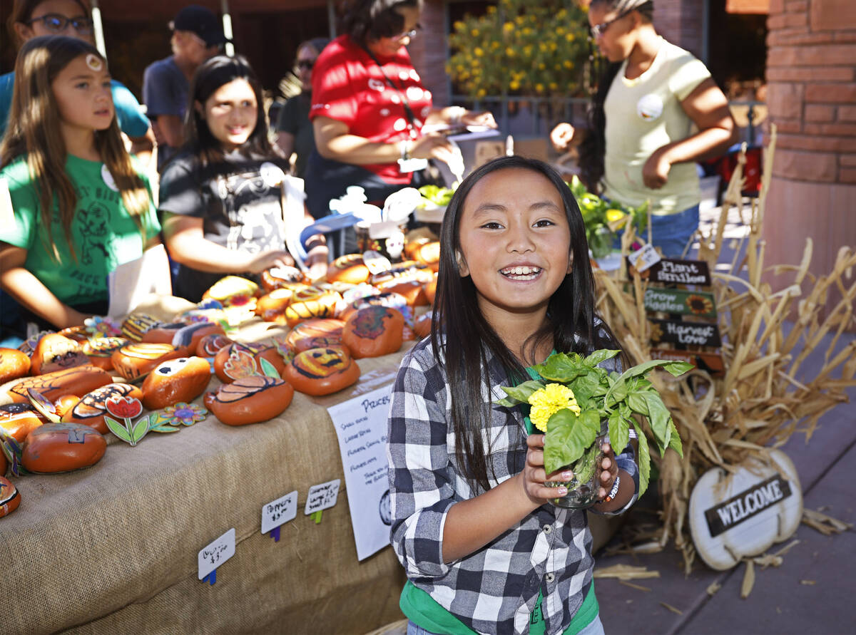 Bartlett Elementary School student Penelope Wong, 9, sells products on Thursday, Oct. 20, 2022, ...