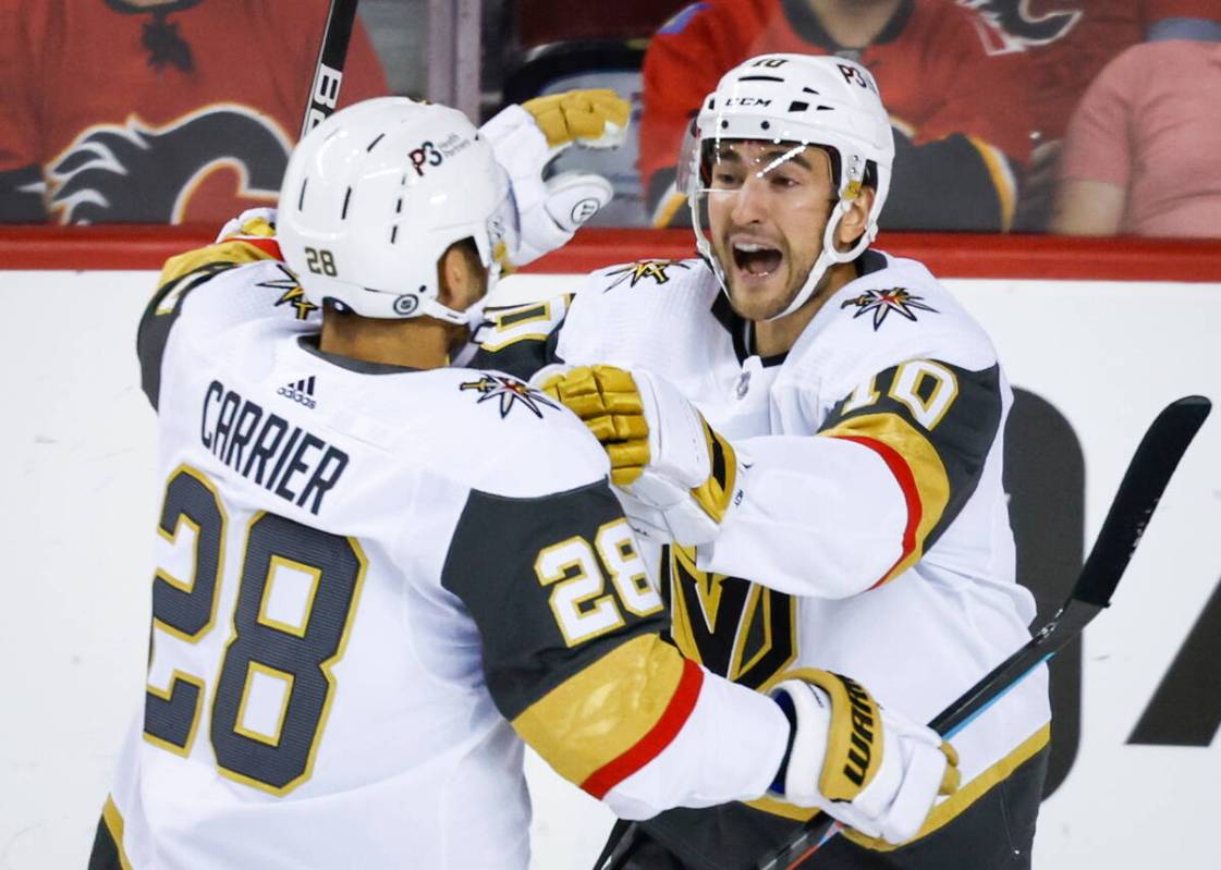 Vegas Golden Knights forward William Carrier, left, celebrates his goal against the Calgary Fla ...