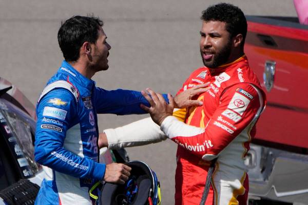 Bubba Wallace, right, and Kyle Larson push each other away after the two crashed during a NASCA ...