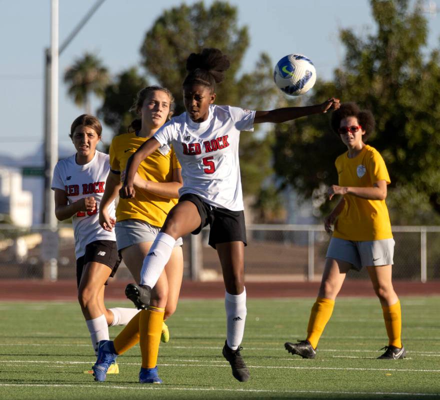 Doral Academy’s Sanyi Thompson (5) jumps to head the ball while Bonanza players follow the ba ...