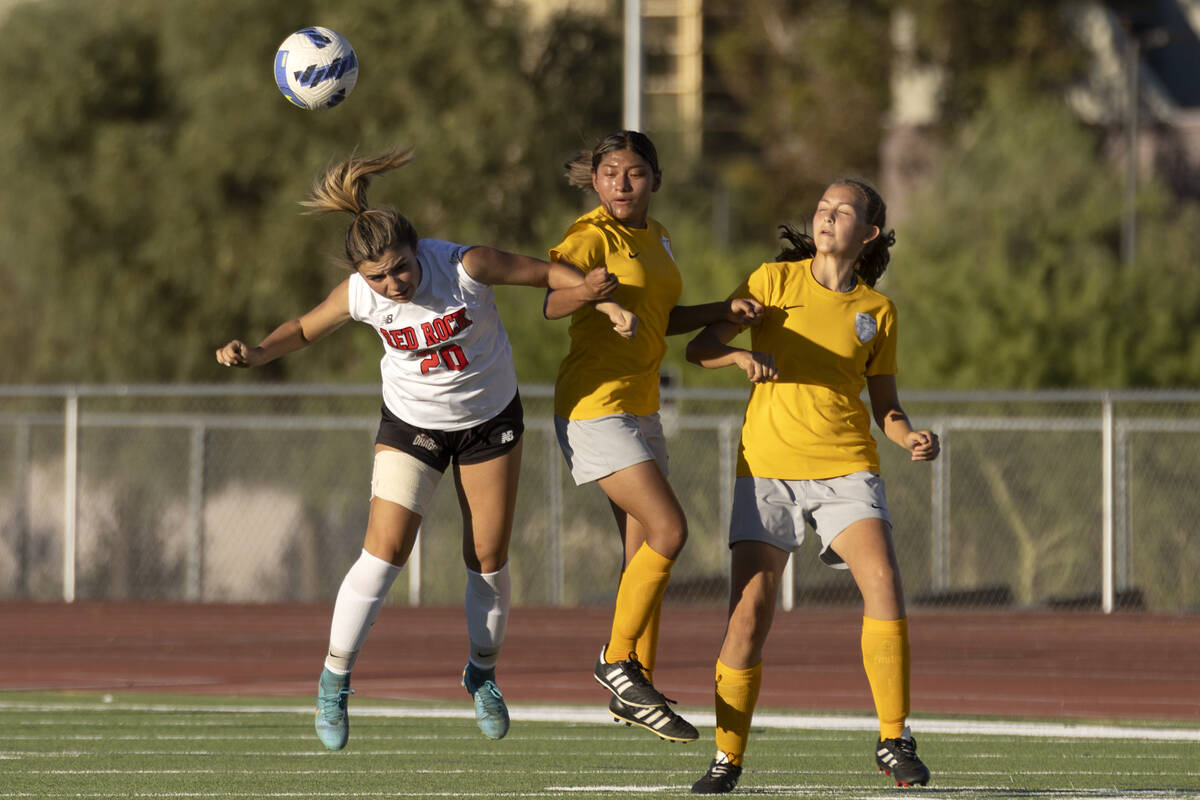 Doral Academy’s Gianna Davis (20) jumps to head the ball alongside Bonanza’s Mayr ...