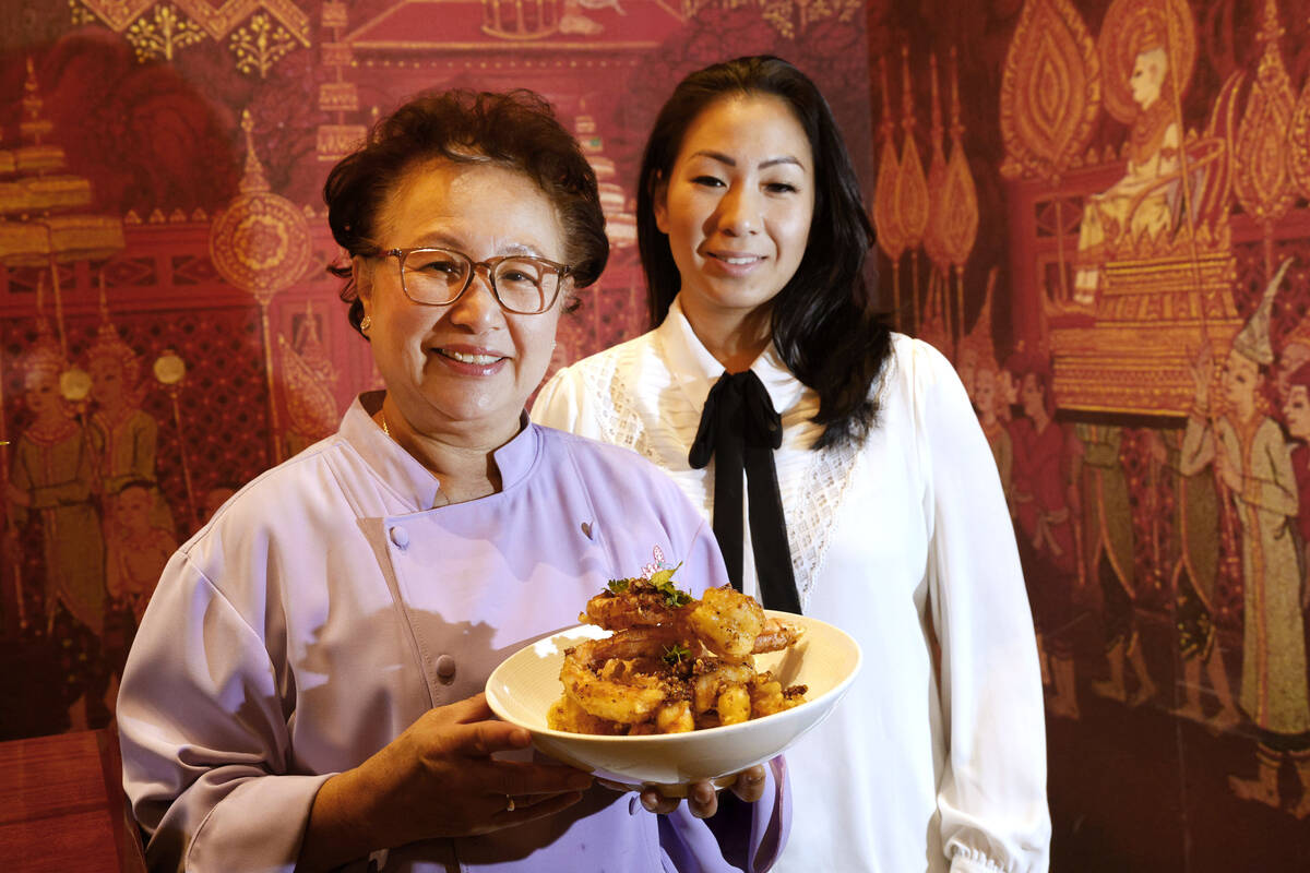 Lotus of Siam owner/chef Saipin Chutima, left, shows a dish of Garlic Prawns with her daughter ...