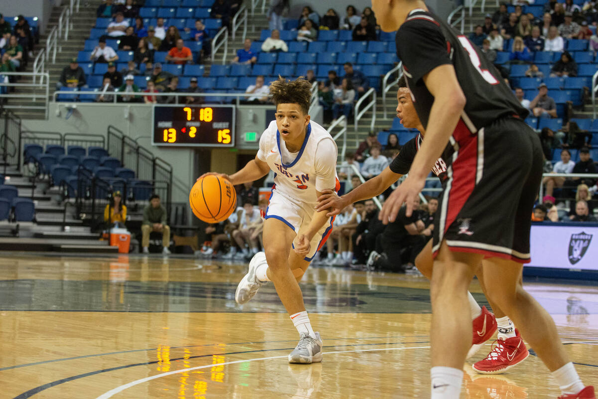 Bishop Gorman's John Mobley dribbles around Liberty defender Dedan Thomas Jr. during the NIAA C ...