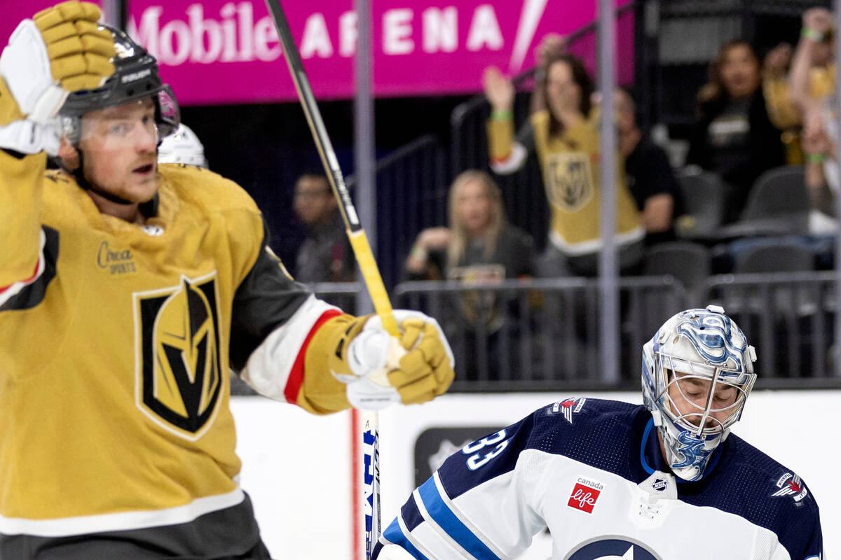 Golden Knights center Jack Eichel (9) skates around the net after scoring a goal on Jets goalte ...