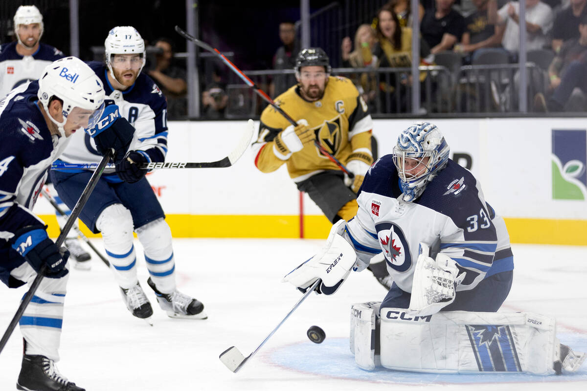 Jets goaltender David Rittich (33) prepares to save a Golden Knights shot on goal during the th ...