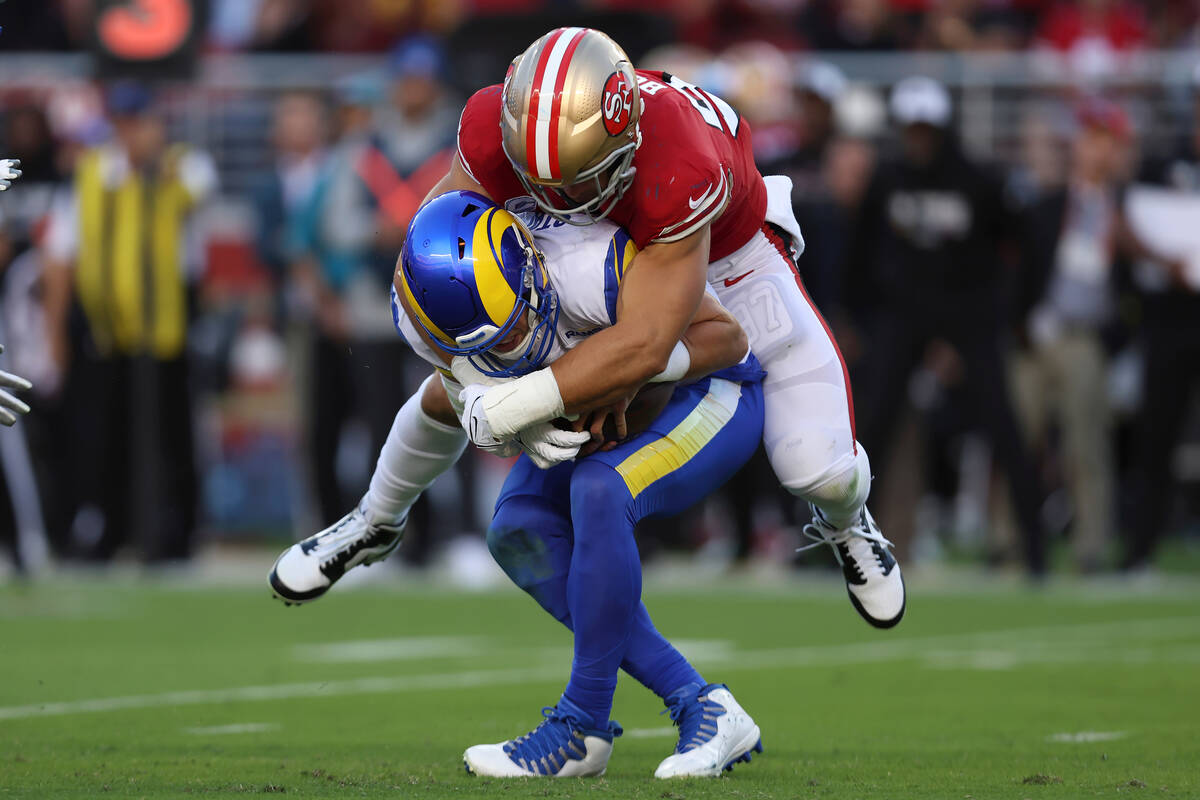 San Francisco 49ers defensive end Nick Bosa, top, sacks Los Angeles Rams quarterback Matthew St ...