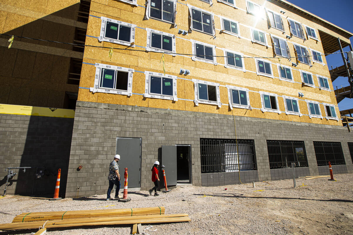 Tiffany Brown, property manager at ShareDOWNTOWN, right, gives a tour to a prospective tenant a ...